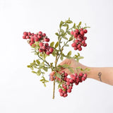 Hand-held detail of 38 cm artificial berry spray in red