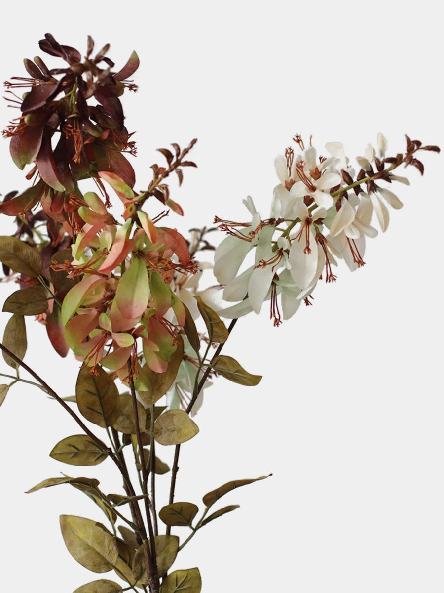 Close-up of ivory, green and burgundy artificial erythrina flowers with slender stamens and fabric petals
