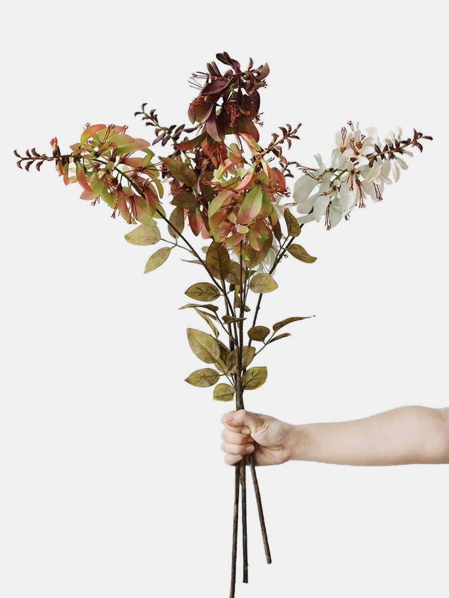 Hand-held group of ivory, green and burgundy artificial erythrina stems showing their branching shape