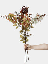 Hand-held group of ivory, green and burgundy artificial erythrina stems showing their branching shape