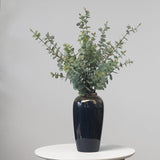 Artificial eucalyptus foliage styled in black vase