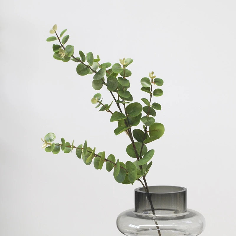 Artificial eucalyptus green stem in glass vase
