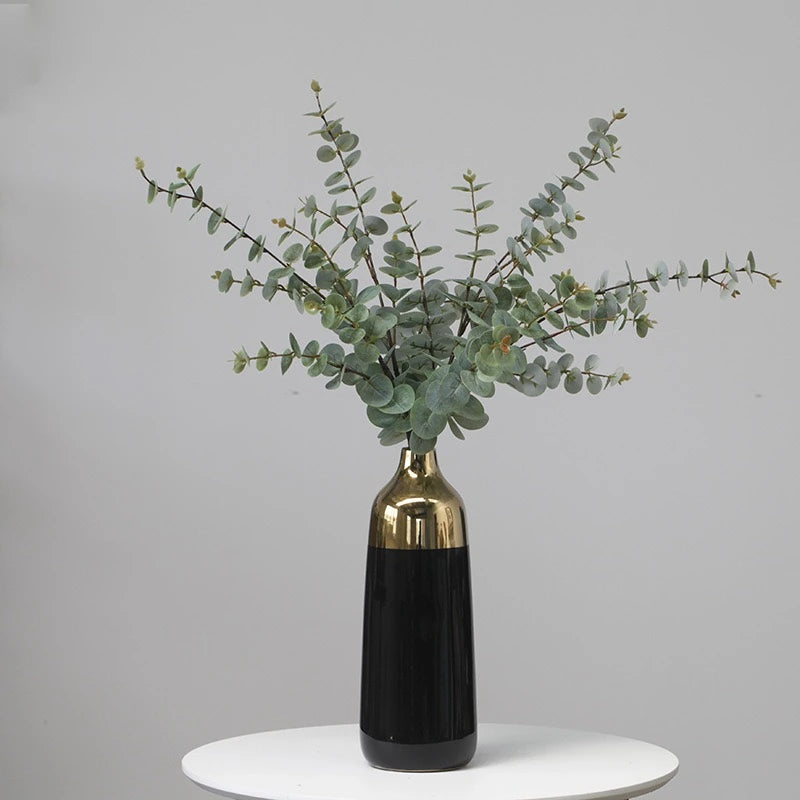 Artificial eucalyptus foliage styled in tall vase