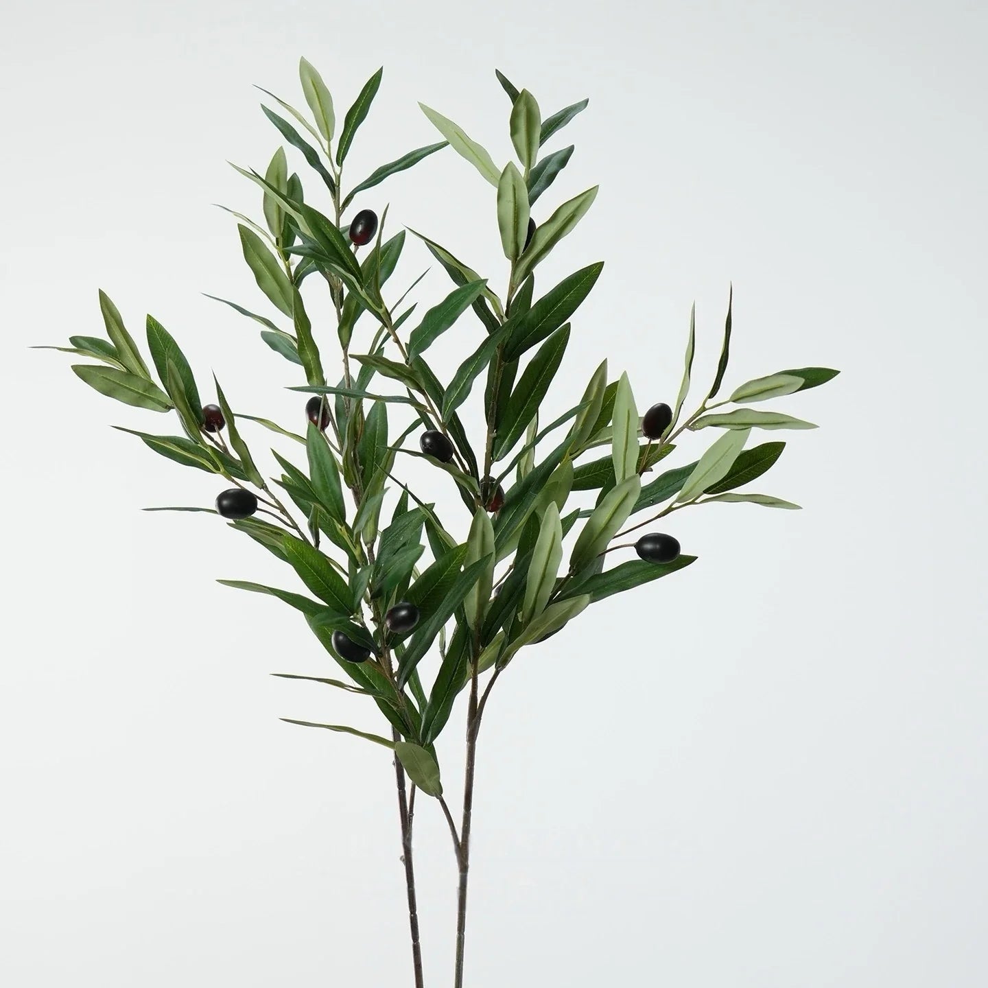 Green artificial olive branch with black olives