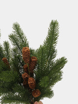 Close-up of green plastic pine needles and elongated brown cones