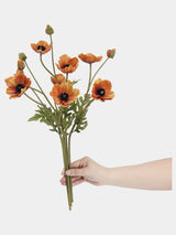 Burnt orange artificial poppy stems held in hand to show the flower arrangement