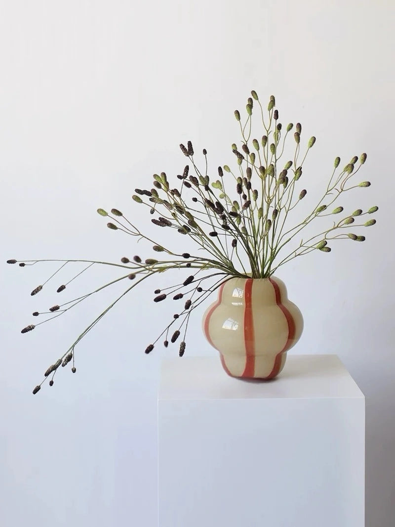 Artificial Sanguisorba stems styled in a vase
