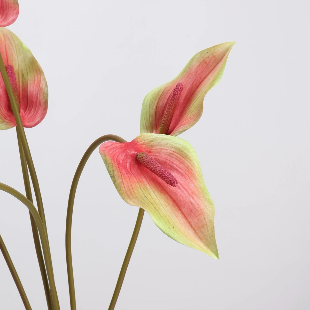 Green and pink faux anthurium flower detail