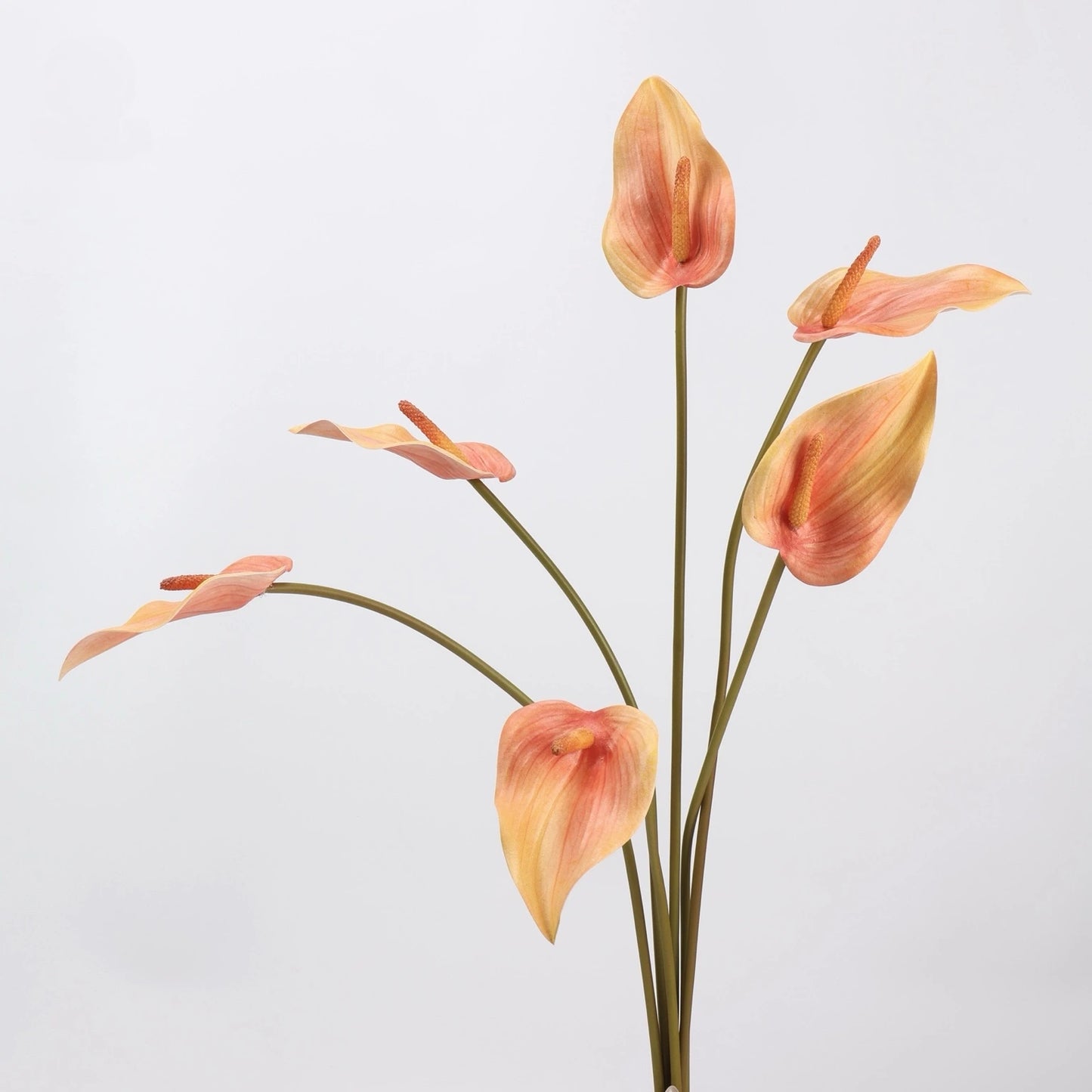 Orange faux anthurium stems grouped together