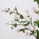 Close-up of light pink faux clematis flowers and leaves