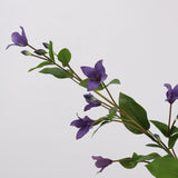 Close-up of purple faux clematis flowers and leaves