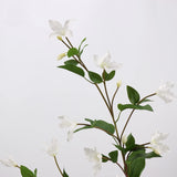 Close-up of white faux clematis flowers and leaves