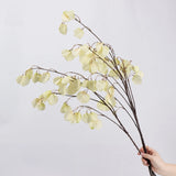Cream faux lantern pod branches shown by hand