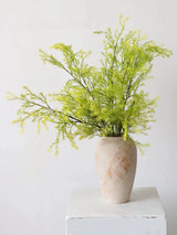 Light green faux melaleuca foliage styled in a vase; vase not included