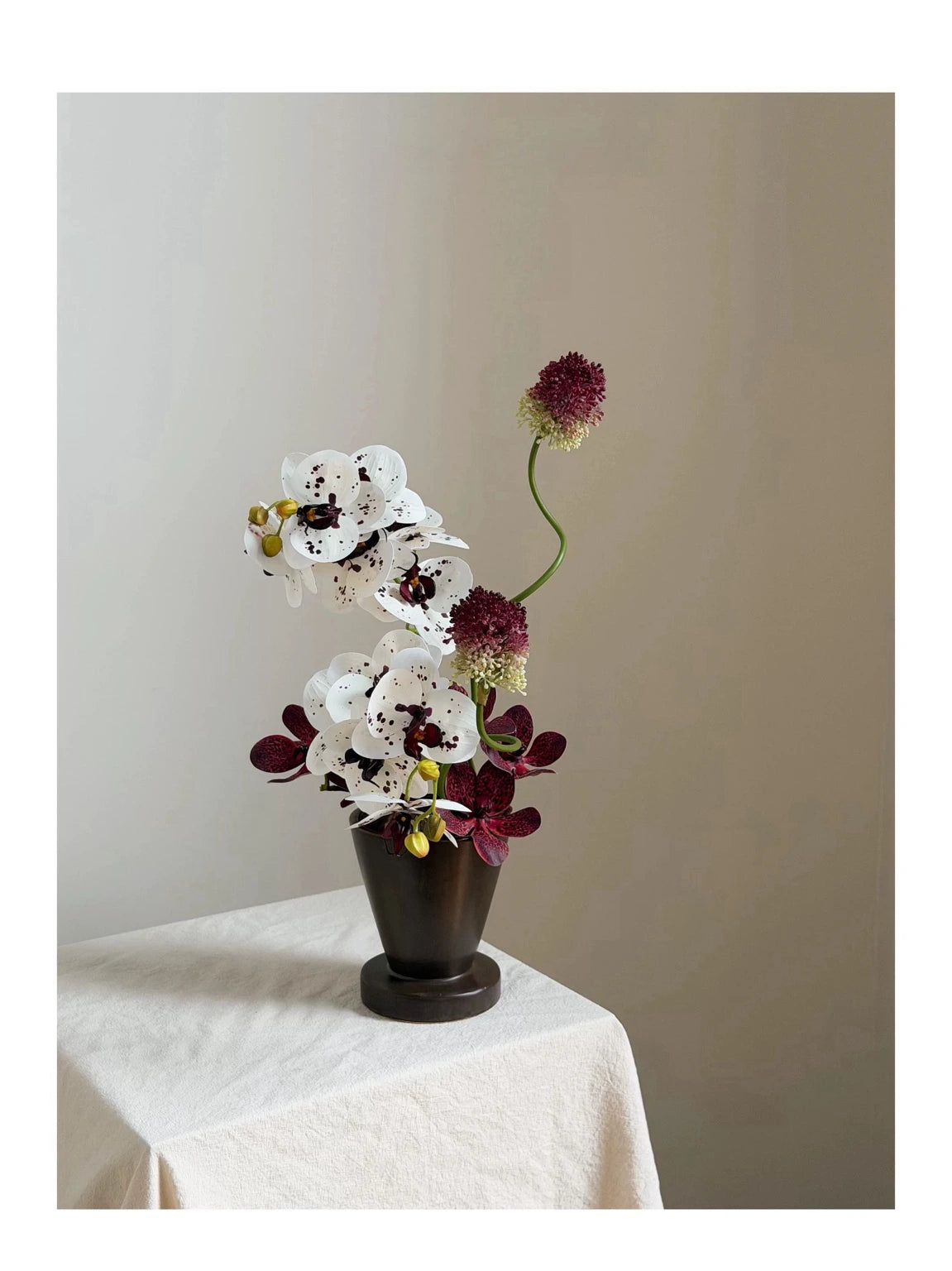 Burgundy and white artificial orchid floral arrangement