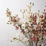 Faux autumn butterfly orchid stems styled together