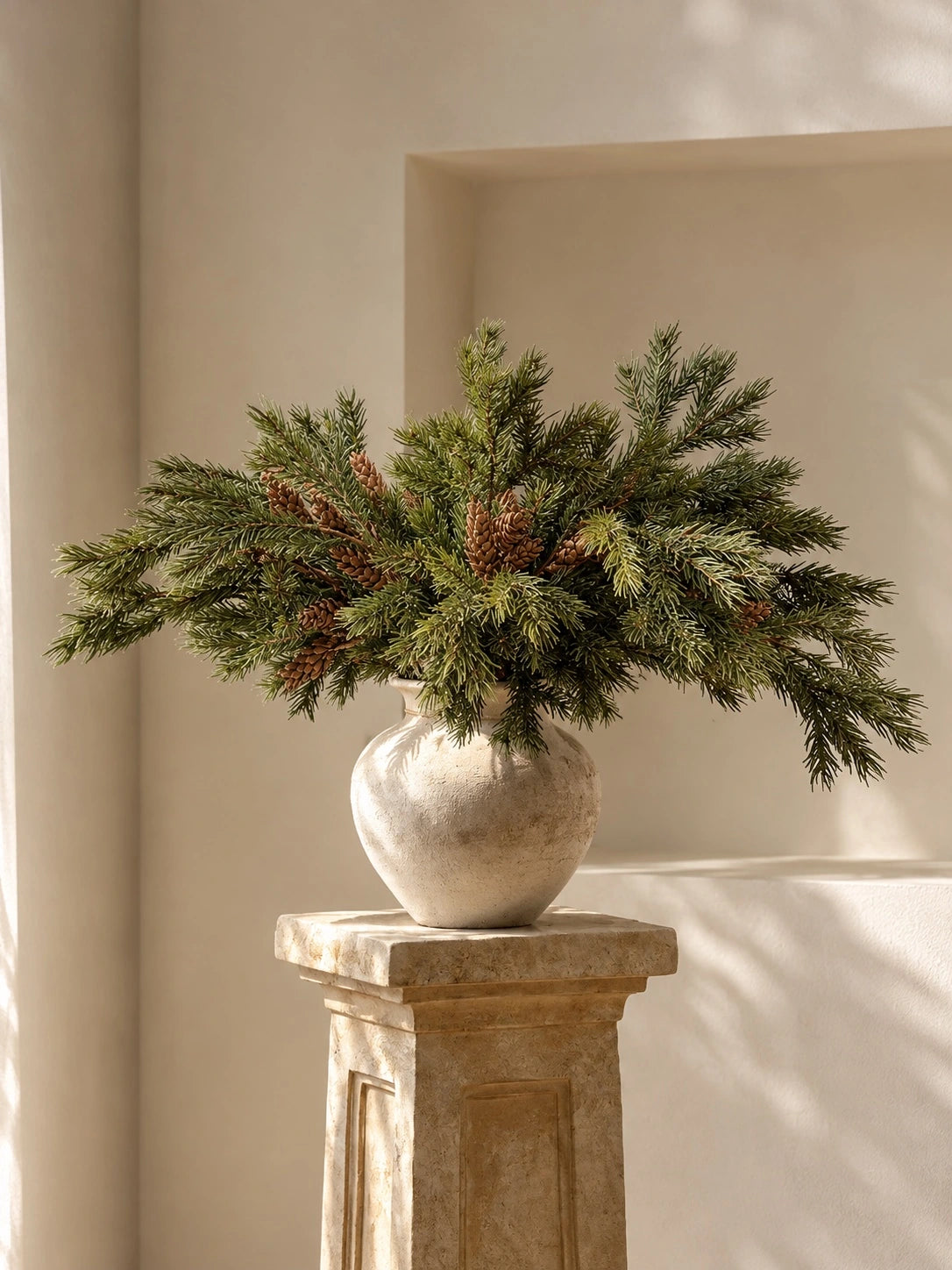Faux Norfolk pine branches arranged in a vase; vase not included