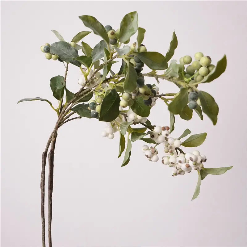 Green and white faux berry branches together